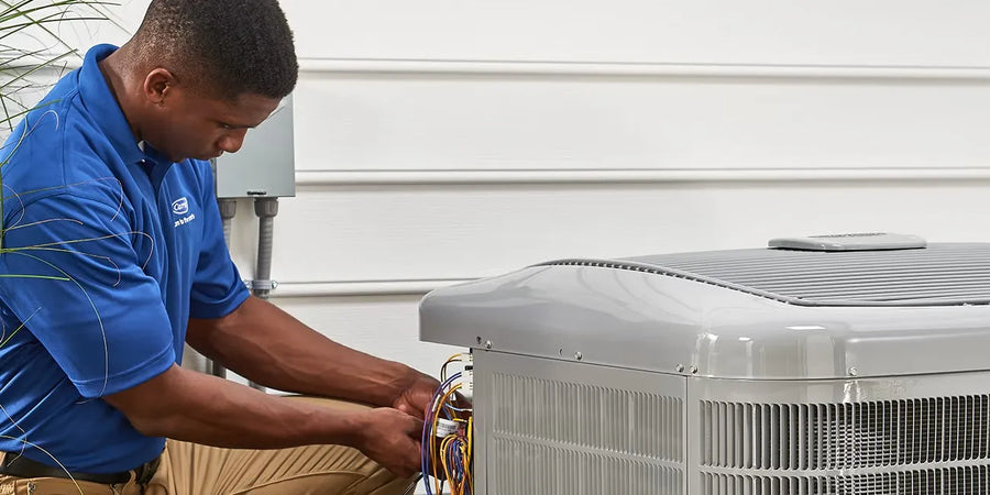 Person working on an air conditioning unit outdoors